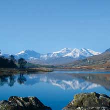 Beautiful Snowdonia reflected in a lake near Capel Curig Community Centre, North Wales.